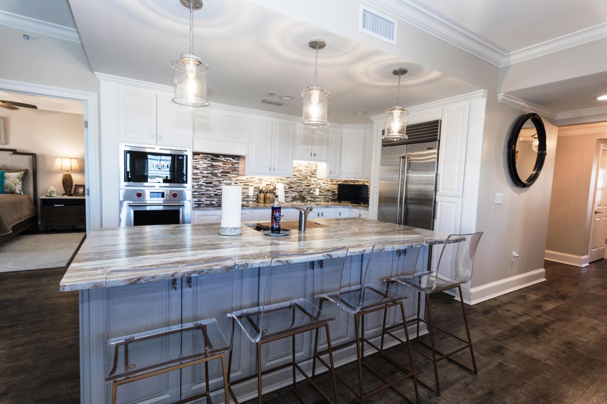 Stunning views, a gourmet kitchen, spa-like primary bath, and a large open floorplan perfect for entertaining! These are just a few of the features of this stunning 3 bedroom, 3 bathroom condo at the Grand in Bay Point. Just past the lovely foyer area, step into the spacious dining and living areas featuring great views of both the water and the golf course and flooding the space with natural light. The open floorplan is perfect for entertaining. Generous room sizes, the open floorplan, and warm glow of natural light make this space feel much more like a home than a condo.