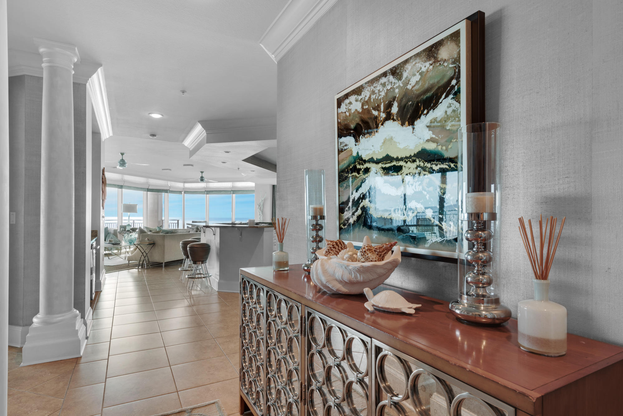 Reminiscent of the Southern California coast, this Signature Beach condo effortlessly blends coastal elegance with splashes of rich luxury. Upon entering, views of the Emerald waters are endless and natural light floods this space through floor to ceiling windows. Contemporary architecture, lavish finishes, and designer furnishings fill this luxurious four bedroom condo. Professionally designed with custom furniture, lighting and cabinetry; no detail was overlooked in renovating this home and sweeping views of the Gulf of Mexico from almost every room provided the perfect backdrop. The incredibly designed interior, modern architecture, covered parking, a rooftop terrace with sleek infinity pool, and low density beaches make it one of the most sought after luxury condominiums in Destin.
