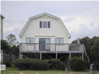 Great beach house just to kick back and enjoy! Not fancy just comfortable. Wide deck and large back yard for pool if desired. Check this out the possibilities are endless, location is across from beach access. Buyer responsible for exact room sizes and sq. ftg. if this is important to Purchaser. The required Energy Efficiency Rating Brochure is attached to this MLS listing. Please ask your sales associate to print it out. Thank you.