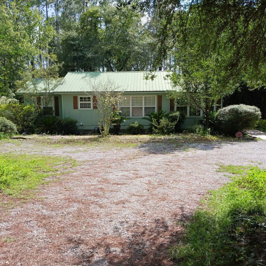 Secluded slice of paradise in the woods only 30 minutes from the beach. Cozy 2 bedroom 2 bath house on over 4 wooded acres between Freeport and Defuniak. Owner started an renovation and had to stop so it still needs a little finishing up. Home has new HVAC, appliances, including washer and dryer, floor covering, paint and stain on the decks. There is an open floor plan with vaulted ceilings in the living/dining area and Kitchen. Private screened 8x24 back porch with extensive decks and wooden walkways. RV carport with storage building. Additional Large Storage shed across the driveway. Small wet weather stream at rear of property. Plenty of room and zoned for some types of home business or animals.