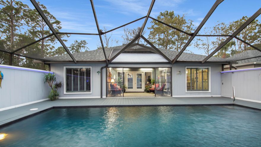 Beautiful custom home nestled on an extra large lot in the well established neighborhood of the Glades. You can stroll up the lighted boardwalk to the front door or enter through the kitchen by the garage. The grand living room features 18 foot ceilings with new skylights surrounded by wood inlay and easily illuminated at night for lovely ambiance. There is a wet bar and plenty of room for a large TV. The renovated kitchen features all new appliances, quartz countertops, LVP flooring and stainless single basin sink. The living room, kitchen and master bedroom feature large windows with plantation shutters overlooking the stunning pool and outdoor living area. The dazzling pool is completely screened in and enclosed making it feel like your own private oasis. New roof, A/C, pool filter,