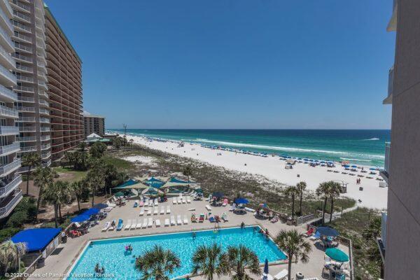 '' Gulf Front '' Beautiful 2BR/2BA fully furnished rental ready condominium. Condo has updated Cabinets, Counters, flooring, sliding doors, windows and AC. Kitchen w/breakfast bar. Wonderful Gulf Front views from kitchen, dining room, living room and master bedroom. Large balcony overlooking beautiful beaches and 1 of 3 pools. This is a wonderful rental investment or great second home. Dunes of Panama has 3 pools, clubhouse, tennis, pickleball, shuffleboard, fitness room, Snack shop and a place to grill. All dimensions are approx.