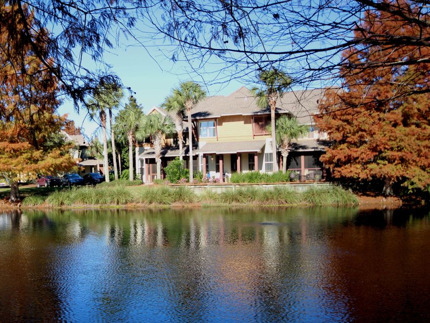 Nestled on the lake in the small neighborhood of Magnolia Bay, this 3 bedroom, 3 1/2 bath townhome offers ''Resort Living'' at it's Best! A short golf cart ride to the beach and minutes from the Village at Baytowne Wharf, this location is second to none. This 2 story home is open and airy with 20' ceilings in the living area, providing for lots of windows and plenty of sunlight throughout. The casual dining and comfortable living room are adjoined and perfect for entertaining. This home features master suites on the first and second levels, beautiful Travertine flooring in the living areas, granite counter tops in the kitchen, a single car garage, and so much more. This home also features 8' mahogany French doors that open to the screened porch, surrounded by lush landscaping and