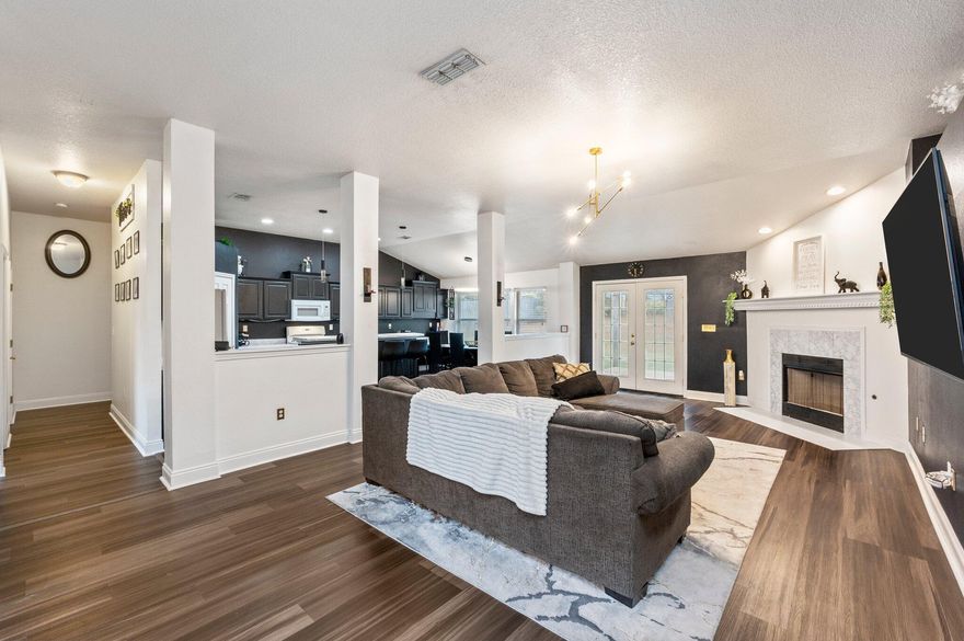 This stunning four-bedroom home, located in a preferred subdivision, offers everything you need for comfort and style. Enjoy access to a community pool for summer fun and a modern design that makes this home feel like your own. The welcoming entry features vaulted ceilings, an open floor plan, and a cozy fireplace, complemented by a breakfast bar and new laminate wood flooring. The split floor plan provides privacy, with all bedrooms offering ample closet space. Outside, the spacious backyard is perfect for play or relaxation. With a two-car garage and an unbeatable location, this home is a must-see!