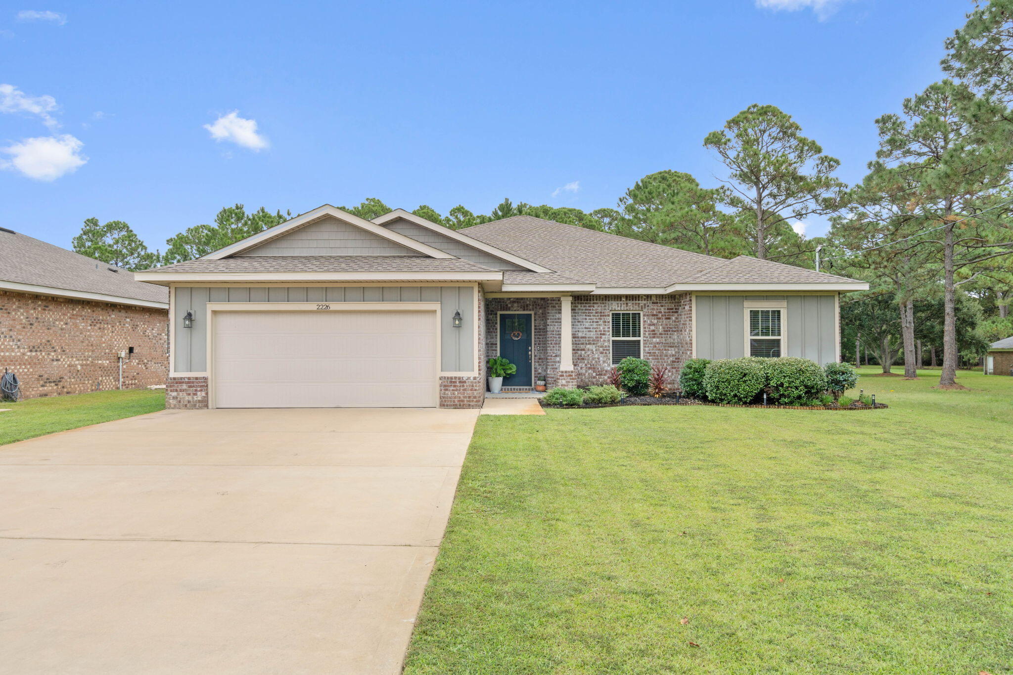 Welcome to this charming home in the heart of Navarre! This lovely house boasts 4 bedrooms and 2 bathrooms, perfect for comfortable living. Step inside to find beautiful wood-like flooring in the main areas, adding warmth and style throughout. The kitchen is a dream with granite countertops, shaker-style cabinets, and stainless steel appliances. Elegant touches like crown molding and trey ceilings in the dining area and primary bedroom elevate the home's appeal. Enjoy the convenience of the included washer and dryer, and admire the unique transom windows over hallway entryways. Outside, you'll find a fully fenced backyard on a spacious .51-acre lot. Relax on the covered back porch or tend to your garden with the well-fed sprinkler system.