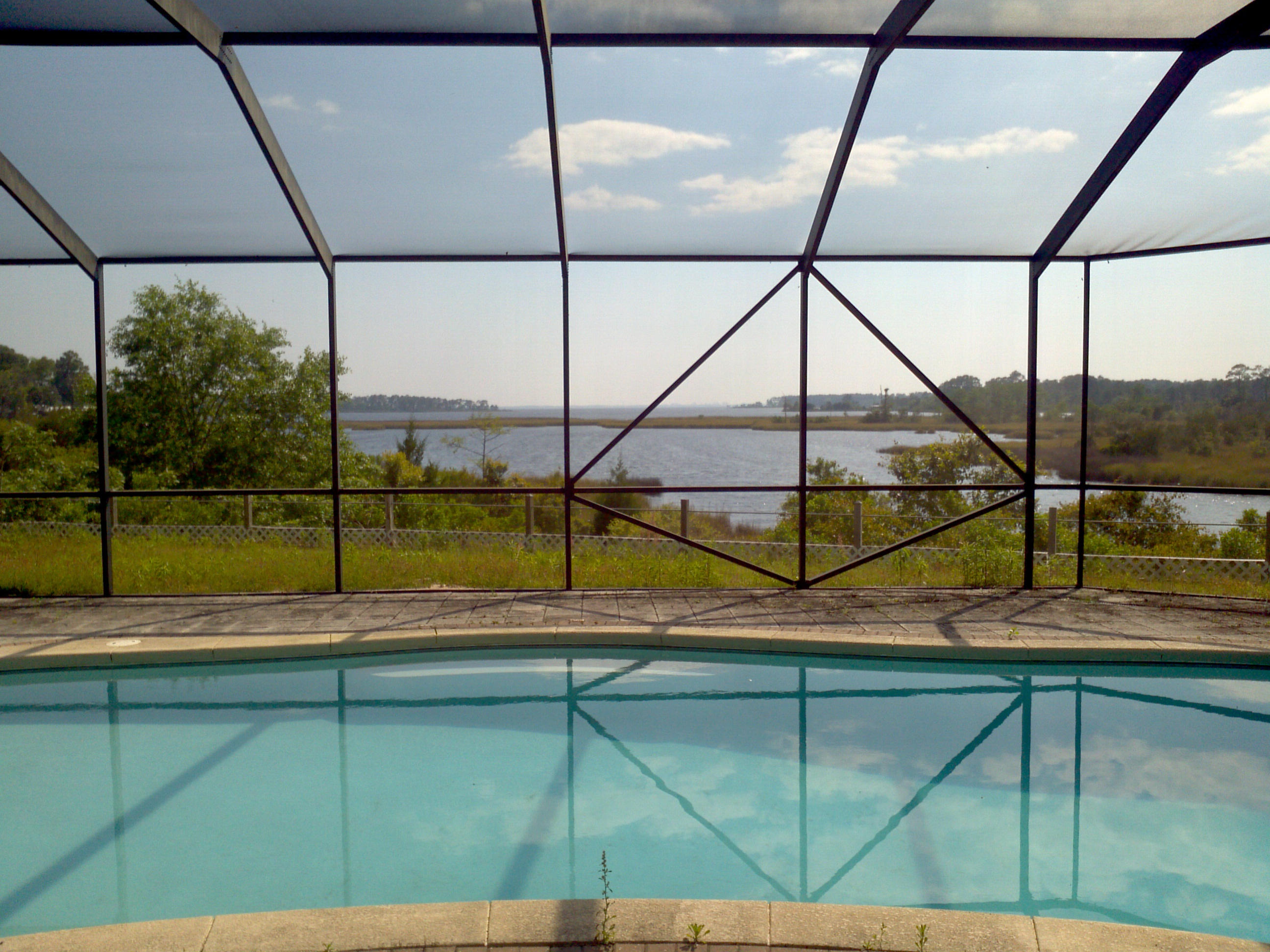 Luxurious Waterfront Retreat. If You Seek Privacy & Spectacular Views This Is The Estate For You! Located On Alaqua Bayou With Views To Choctawhatchee Bay And South Walton. The Estate Is Situated on 13 Private Acres With 910 ft of Bayou Waterfront. The Entrance Winds Along An 1100 ft Creek on the North Part Of Lot. The House With Screened Pool And Loggia Has So Much To Offer. A Beautiful Entry With Waterfall. There Are Two Bedrooms, Dining Room, And An Office Area On The Front Portion Of The Home. Walk Down The Hallway To A Bonus Room, A Large Laundry Room, And Gorgeous Kitchen. There Is A Screened Porch On The North Side Of The Home. Past The Kitchen Is A Master Suite With Huge Bedroom and Bathroom With Sauna. Outside Is A Dock/Boat Slip. This Is One Home To Put On Your List To Must See!