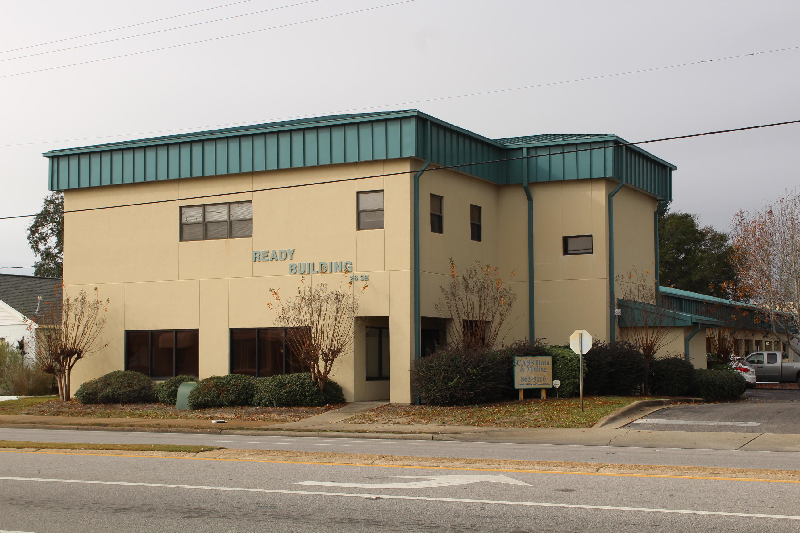 Mostly open floor plan with a few offices and several restrooms. Has rollup door in the rear.