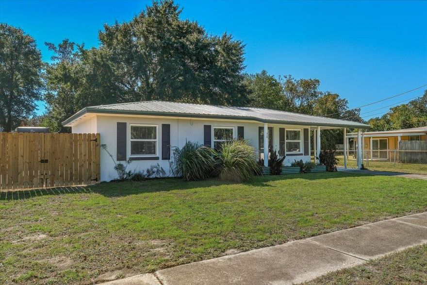 Beautifully renovated home with a new kitchen in 2022 with all new appliances, paint, countertops, and new plumbing in 2024.  All new windows in 2024. Bathroom updated in 2022. New hot water heater in 2024.  Included with the sale of home is the Red Gum Wood dining room table and benches with storage in table and benches.  King size bedframe with storage underneath and built in Red Gum Wood night stands.  New paint and all tile flooring.  The exterior features include: newly added gate fence leading to a concrete pad for boat/RV storage, large fire pit with lighting, 8 raised garden beds, chicken coop,  Large shed, Fruits trees consisting of Guava, Avocado, fig, & grape.  There is a large screened in porch with tile flooring. Home rewired in 2022. New roof and HVAC in 2019