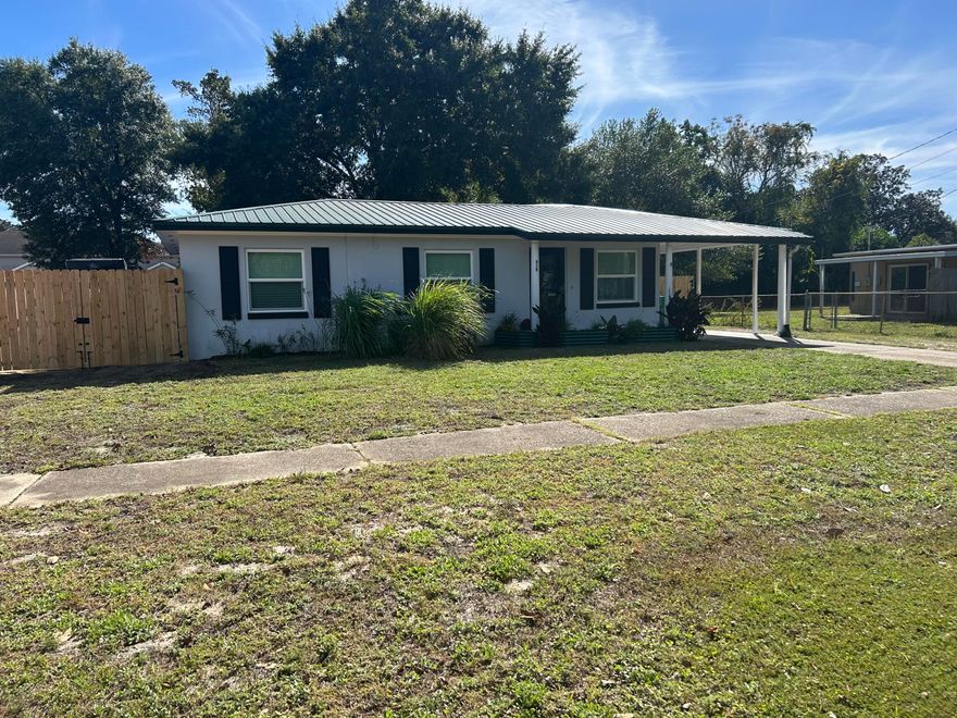 Beautifully renovated home with a new kitchen in 2022 with all new appliances, paint, countertops, and new plumbing in 2024.  All new windows in 2024. Bathroom updated in 2022. New hot water heater in 2024.  Included with the sale of home is the Red Gum Wood dining room table and benches with storage in table and benches.  King size bedframe with storage underneath and built in Red Gum Wood night stands.  New paint and all tile flooring.  The exterior features include: newly added gate fence leading to a concrete pad for boat/RV storage, large fire pit with lighting, 8 raised garden beds, chicken coop,  Large shed, Fruits trees consisting of Guava, Avocado, fig, & grape.  There is a large screened in porch with tile flooring. Home rewired in 2022. New roof and HVAC in 2019
