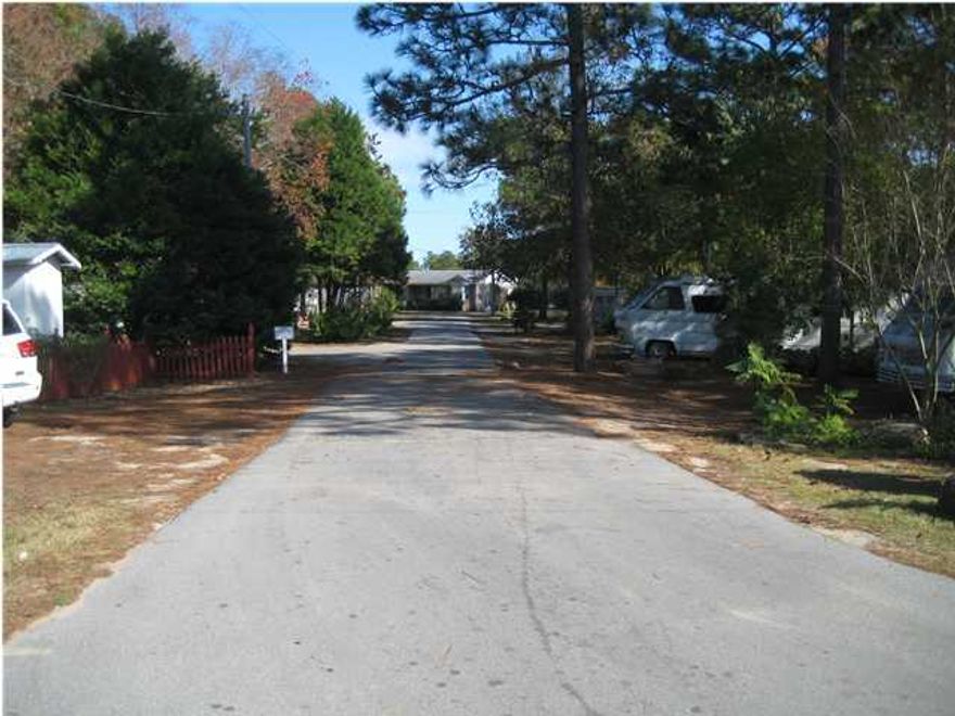 Five Acres of property zoned Village Mixed Use which allows both commercial and residential uses. Residential uses allow up to 12 units per acre. There are no wetlands. Currently this property is utilized as a long term RV Park and Campground. The existing use has been in place since 1983 and has currently 38 rentals producing income.