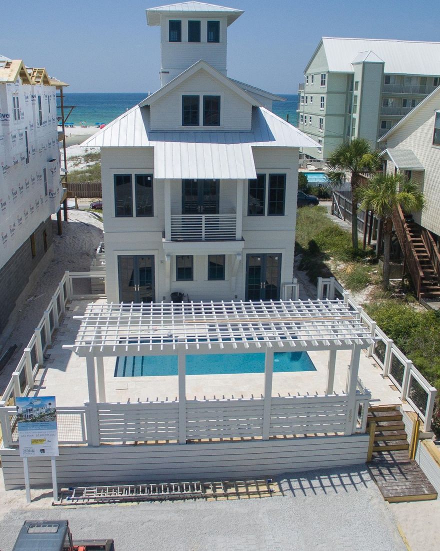 Here's your chance for another beautiful home built by Coastal Elements, the builders of the Maison de Vie showcase home in Watercolor. This home was designed and built to maximize the views not only from the interior rooms, but from the multiple outdoor living spaces. From the large porches off the first and second floors facing the Gulf to the must see views from the 4th floor Cupola and open deck area that offers 360 degree views of the Gulf, Eastern Lake and surrounding area. The house boasts a 1200 sf pool deck area with pergola and outdoor cooking. The first level offers plenty of sleeping space with 4 Bedrooms (one with an extra bunk area for kids), lounge room leading to the pool and 3 bathrooms. The second floor is the main living area with