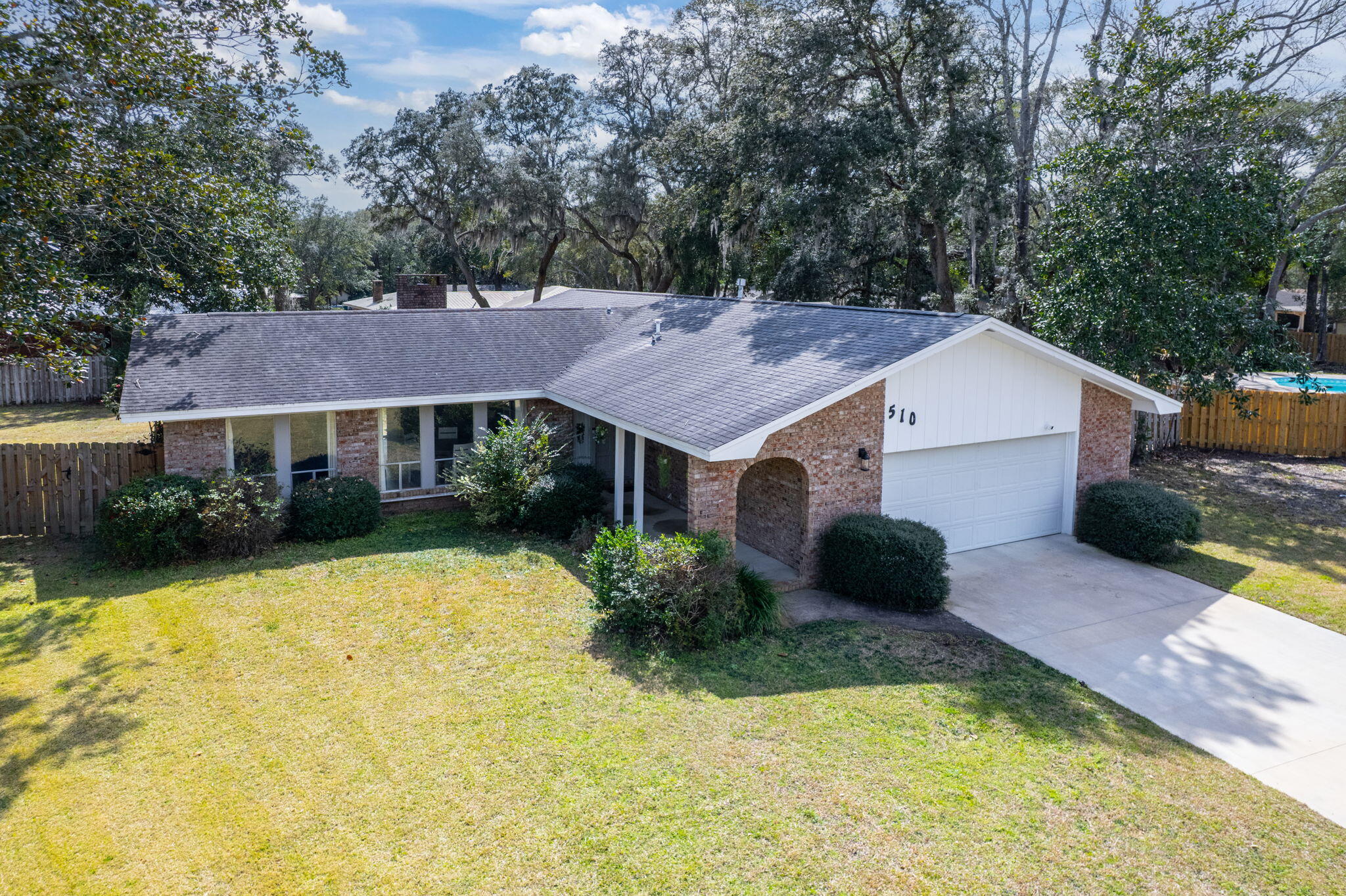 VA Assumption to VA Buyer - 4.6%. Welcome to 510 Sioux Circle, a lovely home in Fort Walton Beach, FL, located in the family-friendly neighborhood of Overbrook. Centrally located to both Hurlburt Field and Eglin AFB, this is an ideal location for Active Duty and DOD personnel. Fort Walton Beach is rich in activities and scenery such as public parks and recreation, emerald water beaches on Okaloosa Island and nightlife downtown. With many shopping and dining options nearby, there's something for everyone. This home features a spacious living area with new LVP flooring installed in 2023 and a cozy brick surround wood-burning fireplace. The back sliding glass door is hurricane-rated for added safety. The open concept design allows for plenty of natural light, complemented by the many recent renovations throughout. The kitchen is a highlight with bright quartz countertops, a mix of stainless steel and white appliances, a modern tile backsplash, and a kitchen island with storage. The primary bedroom offers double closets, while the bathroom includes a double vanity and a large tile walk-in shower with an oversized rain showerhead and a handheld showerhead. Additional features of this home include a new HVAC system installed in 2024, a hot water heater installed in 2022, PEX plumbing, and hurricane shutters. A whole-home Generac generator, serviced yearly with a battery replaced in 2023, ensures peace of mind. The walls and ceilings have been freshly painted, and the driveway was repaved in 2022.
