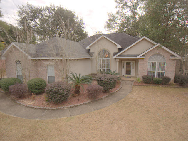 Wonderful home on a quiet street. This location is highly sought after with it's large live oak trees, quiet neighborhoods and the simple commute to the bases from the very south end of Crestview. Once inside, you will find the raised ceilings and gas fireplace welcome you in. There are wood floors, a split bedroom floor plan, enclosed Sunroom with tiled floors, a sunny breakfast nook and a really sweet kitchen that has tiled floors and back splash, granite counter tops,raised ceilings, stainless steel appliances and plenty of room to cook, prepare and serve. The master bedroom is spacious with a nook for a sitting or reading area.The master bathroom has a whirlpool tub, walk-in shower and very large walk- in closet. The foyer has high ceilings and pillars as you enter. Outside is awesome!