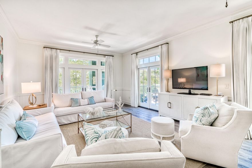 **Under Contract with a 72 hour kickout clause. Nestled in the heart of WaterColor's Town Center, this condo offers the incredible opportunity to own just one block from the beach. Upon entering this spacious corner unit, you are greeted by an open living and dining area surrounded by two spacious balconies with French doors on the western and southern sides offering an abundance of natural light. Off the dining area, you'll find a newly updated kitchen stocked with stainless steel appliances, quartz counter tops, a stainless steel farm house sink and tall white cabinetry for a light and airy feel. This home is adorned with warm toned hardwood floors and large windows throughout.