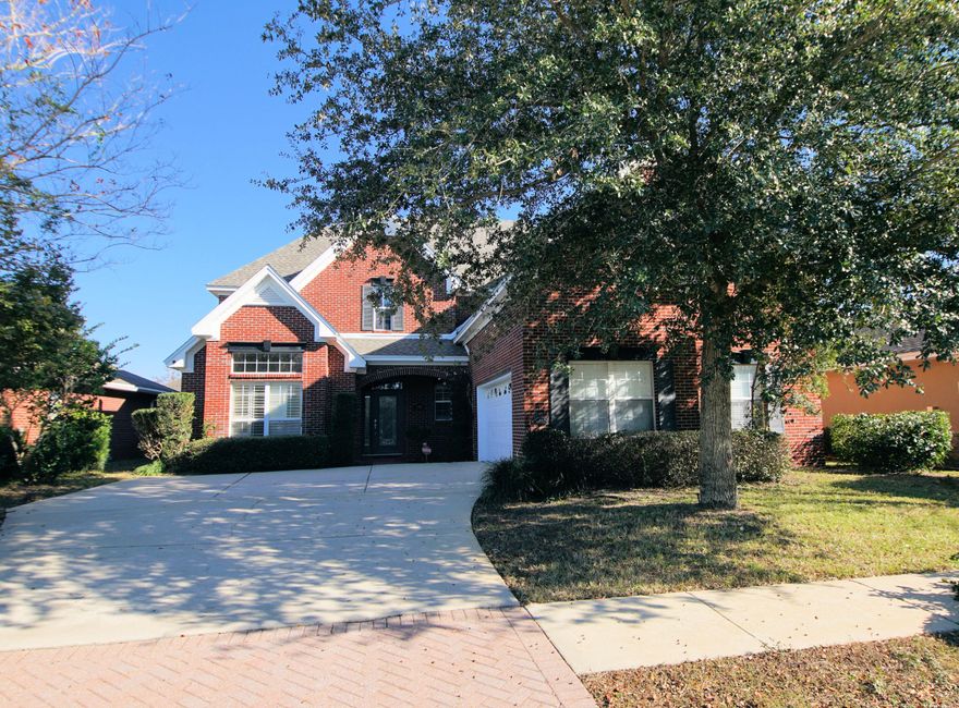 All brick traditional family home in gated community with all the upgrades you would expect: knock down ceilings (no popcorn), crown molding, upgraded cabinetry with crown molding, elevated ceilings, tile and wood flooring, plantation shutters and built in speakers. Covered entry porch and front side loaded garage add to the appeal of this home. Foyer welcomes guests to the study/living room, family room and formal dining. Both living areas feature a gas fireplace. The study also has built in cabinets and shelving for convenient storage. Formal Dining is spacious and features lighted treyed ceiling and wainscoting.
