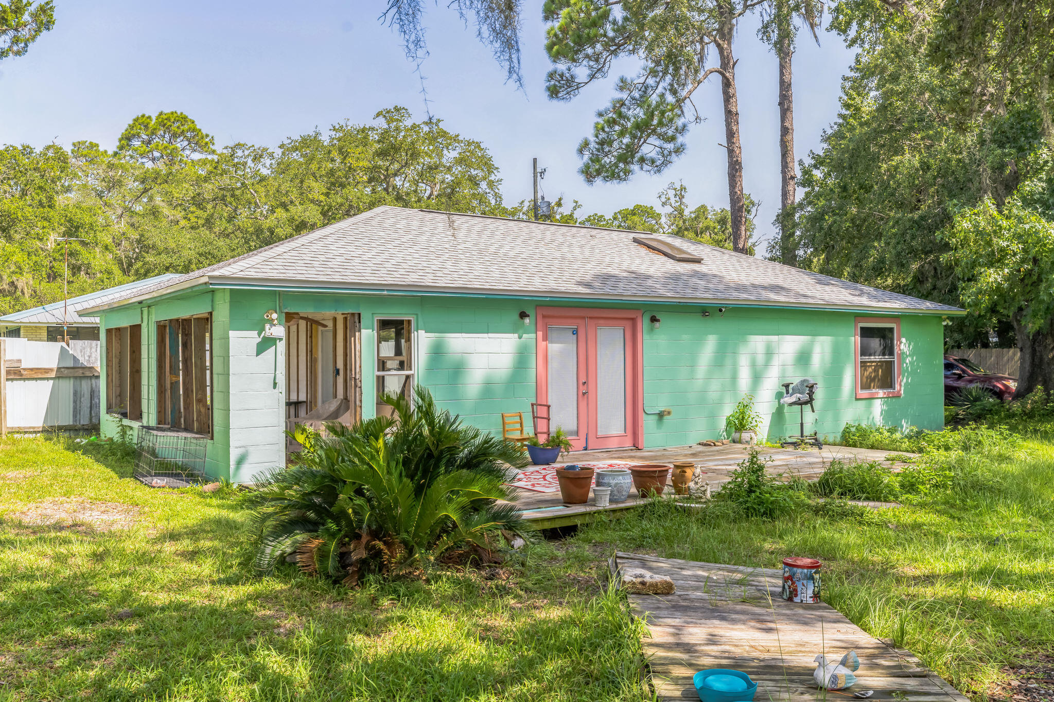 Welcome to this charming 3-bedroom, 2-bathroom home with 1,193 sqft of living space, nestled on a spacious 0.25-acre lot. Built in 1963, this property offers a unique blend of classic character and modern potential. Located just steps from the water, it features a large kitchen with a skylight that fills the space with natural light, complemented by durable tile floors. Enjoy outdoor living on two inviting decks, perfect for relaxing or entertaining. Accessed by a private dirt/clay road, the home does need some minor updates but is in overall good condition, ready for you to make it your own.