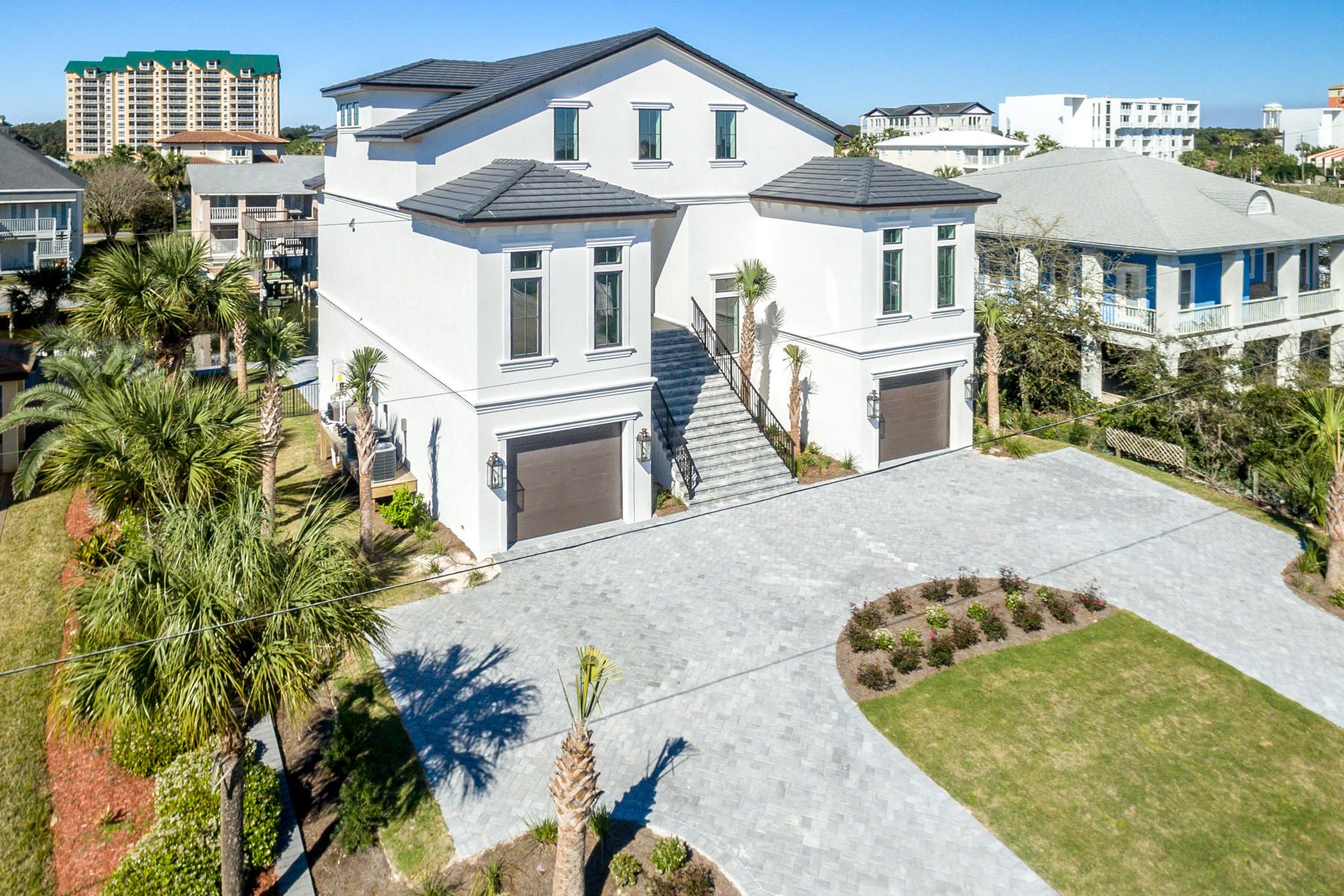 Spectacular waterfront estate in Destin, Florida's exclusive waterfront community of Holiday Isle! This luxurious residence offers approximately 80' of navigable, deep-water, and is only one canal from the coveted Harbor, featuring a wonderful array of restaurants and entertainment. The nearly -1/4-acre prime lot accommodates a 15' x 35' heated, saltwater pool, with an additional 7'x11' wading lagoon, all serviced by an exterior, covered summer kitchen.Measuring approximately 5,577 SF, and three stories, all of which are serviced by an elevator, this newly constructed residence is the ultimate family compound with exceptional structural integrity and superb features and finishes throughout, not the least of which includes the following: stately circular drive servicing two...