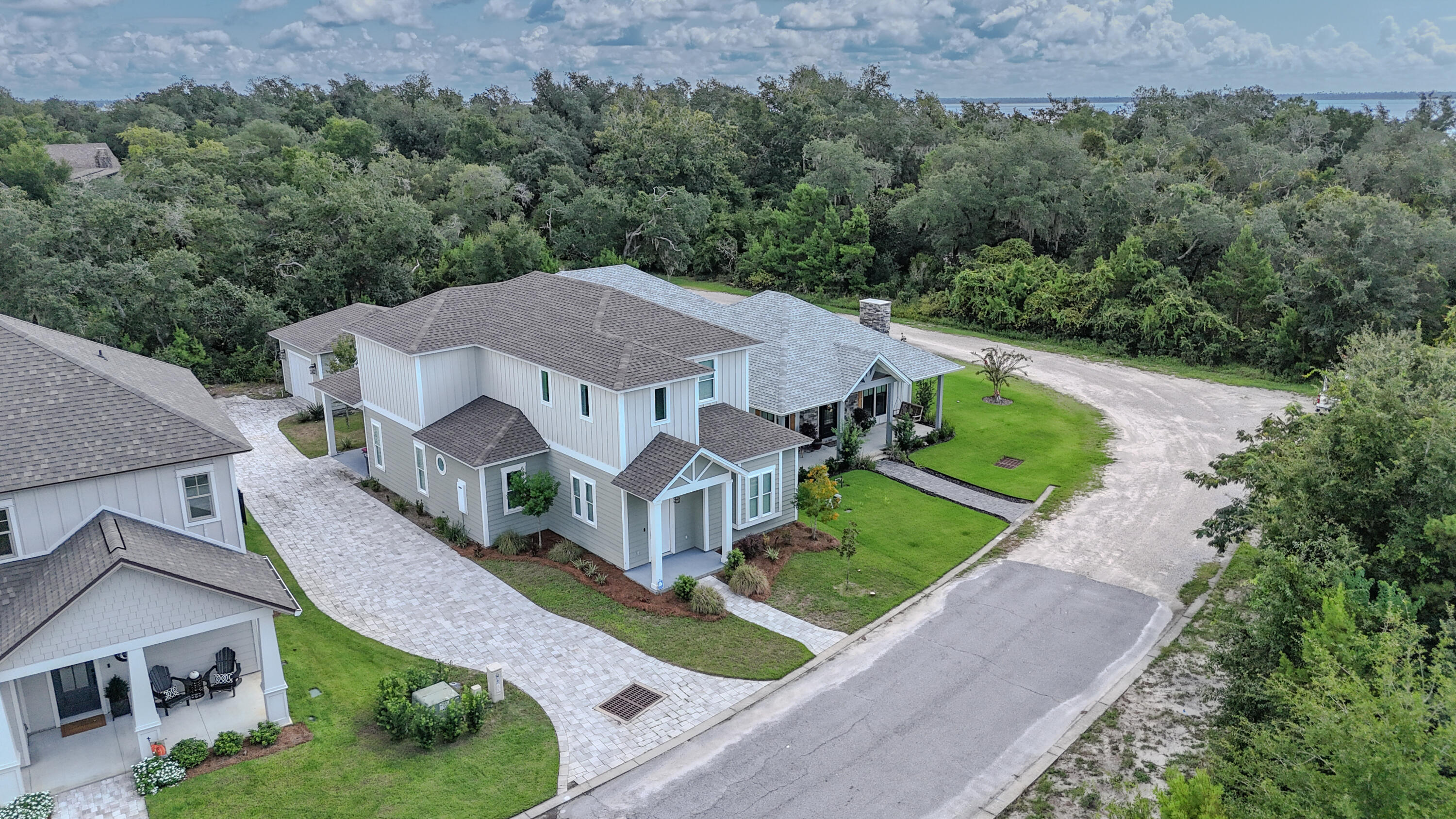 Sanctuary Beach custom home with four bedrooms plus a bunk room. This gated community is steps away from the bay and offers a community pool with dues under a thousand a year. Built in 2021, this is the builder's personal home and has many upgraded features such as herring bone brick floors, 20' entry way, commercial grade double oven, 6 gas burner top, under cabinet microwave, white farm sink, quartz counters throughout, oversized shower, barn doors, shiplap, and much more. The master bedroom and bunk room are downstairs with an additional 3 bed and 2 bath upstairs. The garage provides abundant storage in addition to the long driveway. Located a short drive to marinas, restaurants, golf, and beaches.
