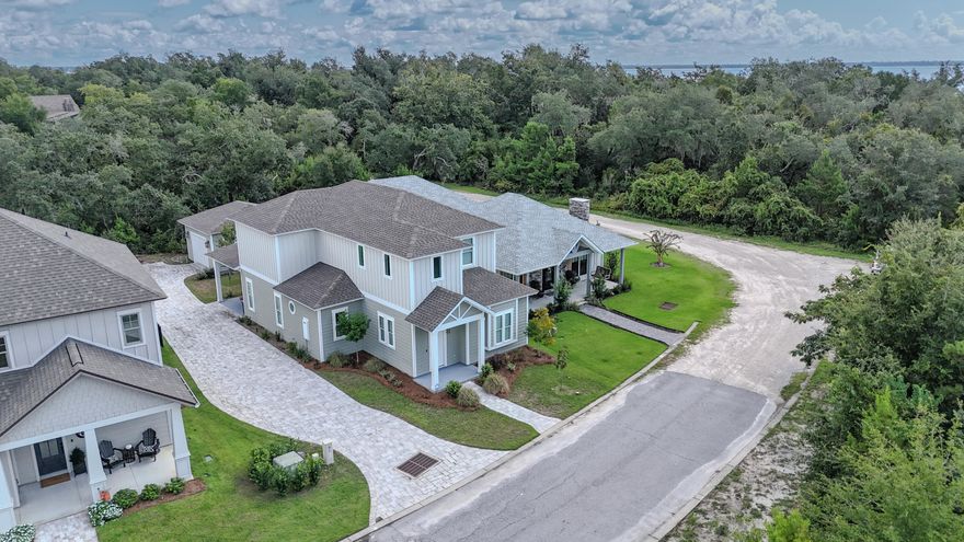 Sanctuary Beach custom home with four bedrooms plus a bunk room.  This gated community is steps away from the bay and offers a community pool with dues under a thousand a year.  Built in 2021, this is the builder's personal home and has many upgraded features such as herring bone brick floors, 20' entry way, commercial grade double oven, 6 gas burner top, under cabinet microwave, white farm sink, quartz counters throughout, oversized shower, barn doors, shiplap, and much more.  The master bedroom and bunk room are downstairs with an additional 3 bed and 2 bath upstairs.  The garage provides abundant storage in addition to the long driveway.  Located a short drive to marinas, restaurants, golf, and beaches.