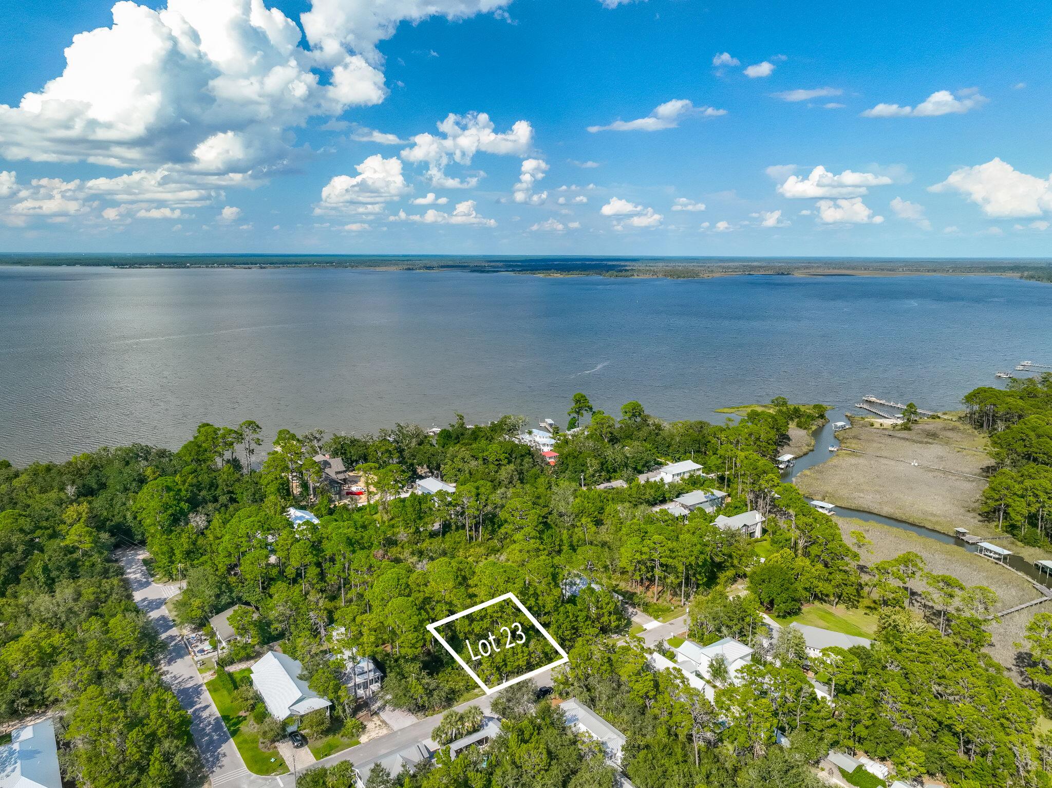 This lot puts you right where you want to be - Right by Choctawhatchee Bay with a community dock and a county park for easy kayak launches, paddleboarding, fishing, and sunset views. Grayton Beach, voted one of the world's top beaches, is less than four miles away with Point Washington State Forest in between, giving you a rare blend of privacy and convenience. Eden Gardens State Park is only .4 miles away, offering a scenic nature trail, picnic pavilion, grills, and a slice of Old Florida charm. Nestled in a community of charming Florida cottages, this lot gives you the freedom to design your dream home, without HOA rules or a buildout timeline holding you back. Picture a custom coastal retreat with porches to catch bay breezes, space for a pool, and trails just down the road. With WaterColor, Seaside, and all the best shopping and dining along iconic 30A only minutes away, this is your chance to create a peaceful retreat surrounded by the natural beauty of South Walton.