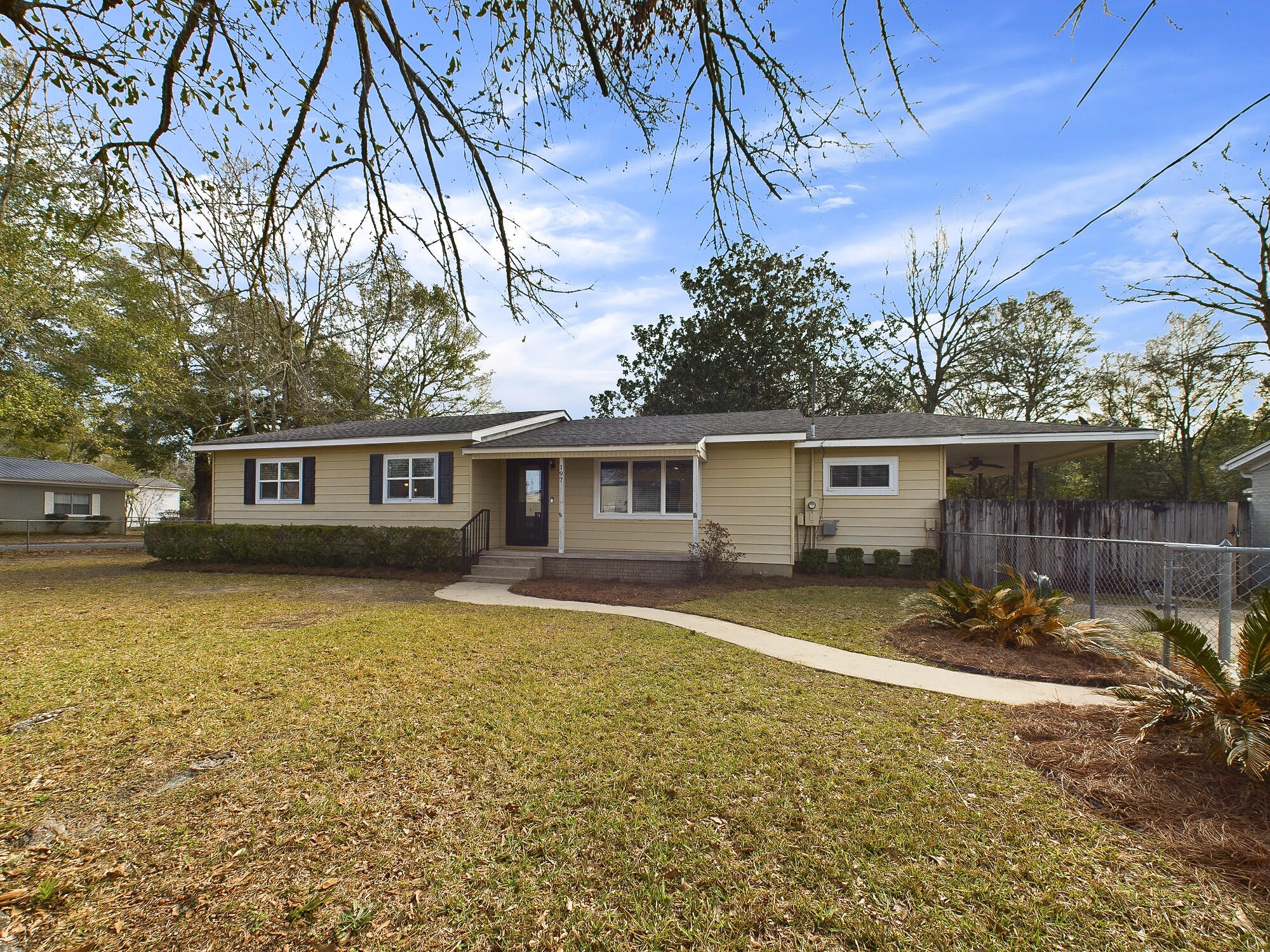This beautifully renovated 3-bedroom, 2-bath home sits on two spacious lots and offers an impressive open floor plan. With an acceptable offer, the seller will replace the roof and hot water heater prior to closing. The HVAC system was replaced in 2012. The home has been completely updated from the inside out, featuring all-new Low E windows, foam insulation, interior and exterior doors, lighting, and ceiling fixtures. The kitchen has been fully remodeled with new granite countertops, cabinets, and stainless steel appliances. The generously sized living room boasts a cozy gas log fireplace, while the expansive 18x24 family room provides versatile space for entertaining. A bright and airy sunroom, updated with new tile and fixtures, adds even more charm. The large bonus room offers flexibi lity as a fourth bedroom, office, or den. The oversized laundry room provides ample storage or the potential for a hobby or work area. Outside, enjoy a large deck with both covered and open areas, accessible from the kitchen, perfect for relaxing or entertaining. The fully fenced backyard includes a large shed and plenty of space for gatherings.
