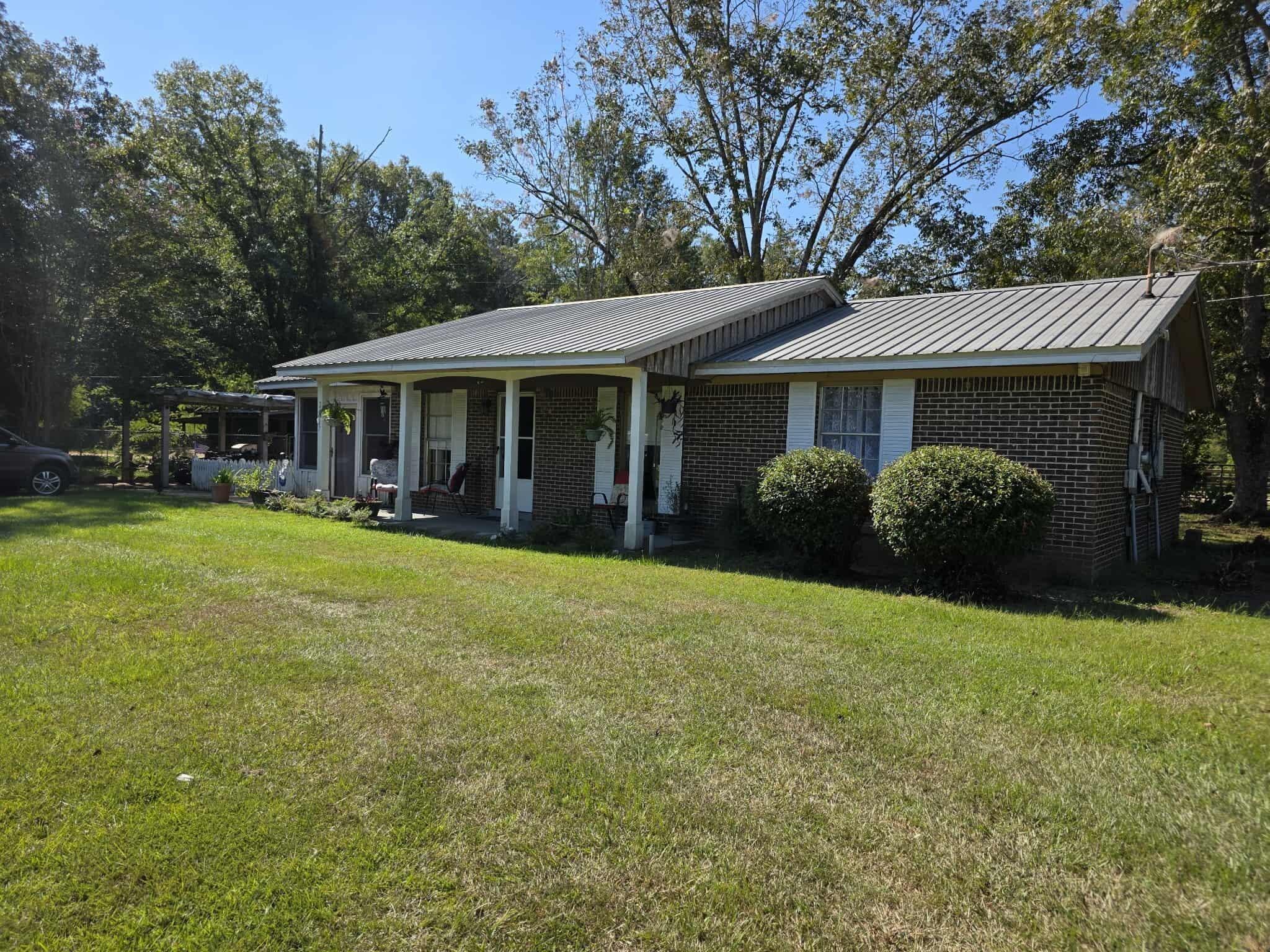 Located on over 0.60 of an acre this 2 BR / 1BA home has so much to offer! All brick with metal roof welcomes you with a covered front porch into an open floor plan concept! Home has a large open kitchen, dining, and living room concept along with 2 great size bedrooms and 1 large bath. The home also includes an amazing large family room perfect for family gatherings, and afternoon relaxing. The property has laminate flooring, tile as well as carpet and has been well maintained and is move in ready at this price. The property has a great side yard for relaxing with a fire pit along with a fenced area for your animals and a greenhouse. The yard has entrances from Lakewood as well as Stateline Road and the yard includes fruit trees and well as pecan trees!