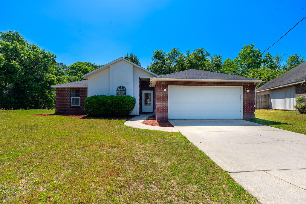 This beautifully maintained All Brick home features brand-new stainless steel appliances and is ready for its new owners. Recent upgrades include a new roof (2021), water heater (2021), and HVAC system (2020), offering peace of mind and long-term value. Inside, you'll find 3 spacious bedrooms, 2 full bathrooms, and 1,578 square feet of comfortable living space. Enjoy the warmth of hardwood floors throughout, a cozy fireplace, and an open-concept living room with soaring cathedral ceilings. The master suite boasts a large walk-in closet and a coffered ceiling for an elegant touch. Step outside to a private backyard with a decka"perfect for relaxing or entertaining. A 2-car garage and ample closet space add to the home's functionality. With easy access to I-10 and military installations.