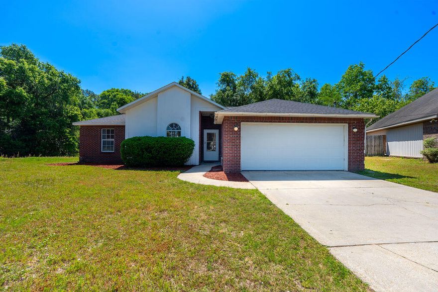 This beautifully maintained All Brick home features brand-new stainless steel appliances and is ready for its new owners. Recent upgrades include a new roof (2021), water heater (2021), and HVAC system (2020), offering peace of mind and long-term value. Inside, you'll find 3 spacious bedrooms, 2 full bathrooms, and 1,578 square feet of comfortable living space. Enjoy the warmth of hardwood floors throughout, a cozy fireplace, and an open-concept living room with soaring cathedral ceilings. The master suite boasts a large walk-in closet and a coffered ceiling for an elegant touch. Step outside to a private backyard with a decka"perfect for relaxing or entertaining. A 2-car garage and ample closet space add to the home's functionality. With easy access to I-10 and military installations.