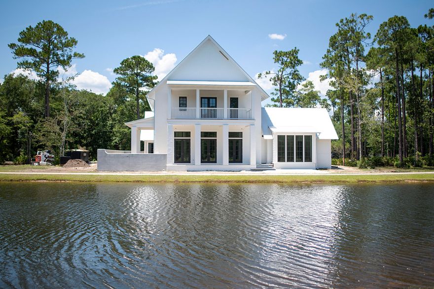 Under construction in Churchill Oaks, this stunning Maribelle plan designed by Savoie Architects is situated on a beautiful spring-fed lake and offers 4 bedrooms with the master on the main level, 4 and 1 half bathrooms, office, and 2-car garage, private pool + extraordinary finishes such as oak hardwood floors, vaulted ceilings and a steel front door. The outdoor living area offers plenty of comfortable lounge space, summer kitchen with grill, private pool and courtyard with lake views and custom designed landscaping. The spacious first floor features an open living area centered around a modern ribbon fireplace and a grand dining room all overlooking the lake. The chef's kitchen features a large pantry + beautiful quartz counters, shaker style cabinets, 48'' 6-burner Wolf range, Sub-Zero