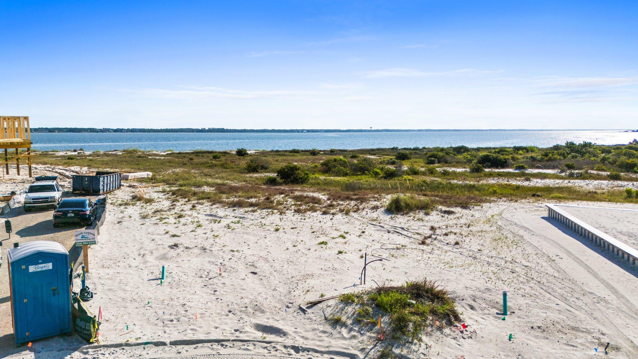 Vacant residential lot with white sand water view, ready for your new build! Deeded beach access in the exclusive coastal subdivision of By The Sea. Close to the Sound and the Gulf with fabulous views of each! Community has 458 ft of shoreline along Santa Rosa Sound and is located between 80 acres of Santa Rosa County Park land and 8 miles of undeveloped federally protected Gulf Islands National Seashore. By the Sea residences architecturally restricted with design in the style of Seaside and Rosemary Beach in Destin. Sea turtle friendly lighting, brick pavers, underground utilities, community pool, bathhouse, outdoor hot tub, fire pit grill and picnic areas, deeded beach access and community park access.
