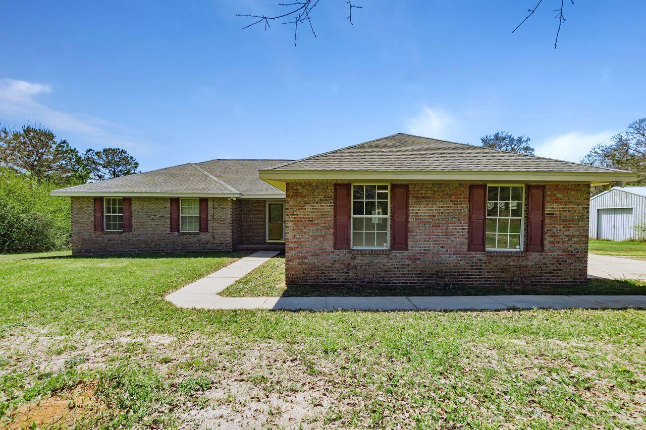 Featuring an all brick 3 bed/2 bath home with a 47x32 metal building (no power to it currently) and sits on 4.06 acres with additional 5.27 acres available for purchase, all zoned Mixed Use. This home also offers a fully enclosed Florida room that leads to a wood deck off the back perfect for grilling and chilling. Pre listing inspection has been done and there are no major issues but could use some TLC. Reroof done in 2018, HVAC 2020 and water heater will be replaced. The living room offers a cozy fireplace HOWEVER, it is a gas insert and has never been hooked up to a gas supply. There is plenty of space in the master bedroom and offers a master suite with a walk in closet. Both guest bedrooms are decently sized with spacious closets.