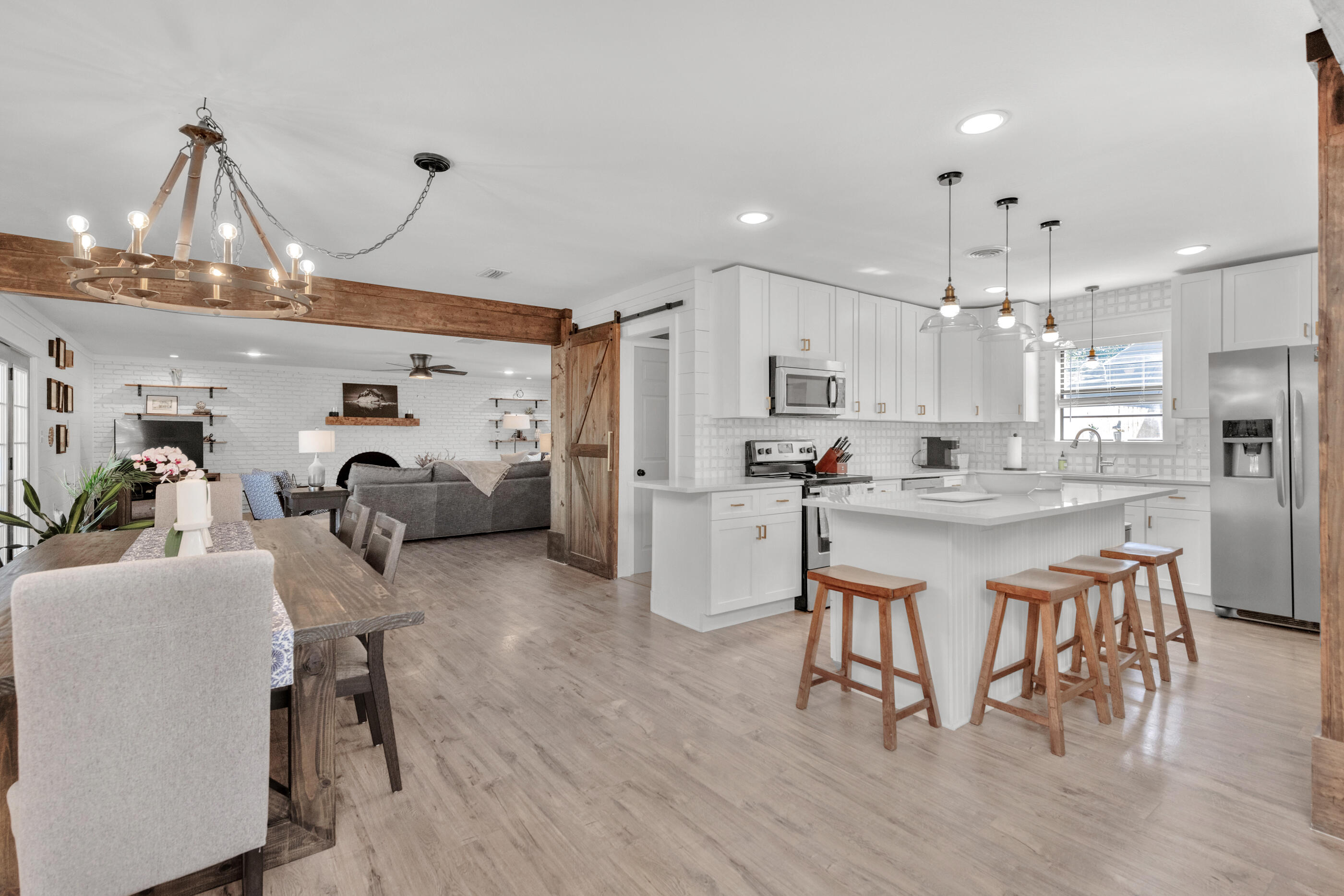 Welcome home to your completely renovated home in the heart of Fort Walton beach! This open floor plan is perfect for entertaining. Enjoy features such as shiplap, brass and iron accents, stained wood beams, a brick wall with a fireplace in the living room, laminate wood floors, and new window and door trim. If that's not enough for you, your new open kitchen features quartz countertops, Carrara marble backsplash, shaker-style cabinets, stainless steel appliances, an oversized stainless steel kitchen sink, and a large island with a wine cooler. Your bedrooms and bathrooms have also been updated included a luxurious master suite with his and her closets, soaking tub, walk-in shower and more! Your new home sits on a larger lot with no HOA. Roof and new wiring since 2020. Schedule a showing!