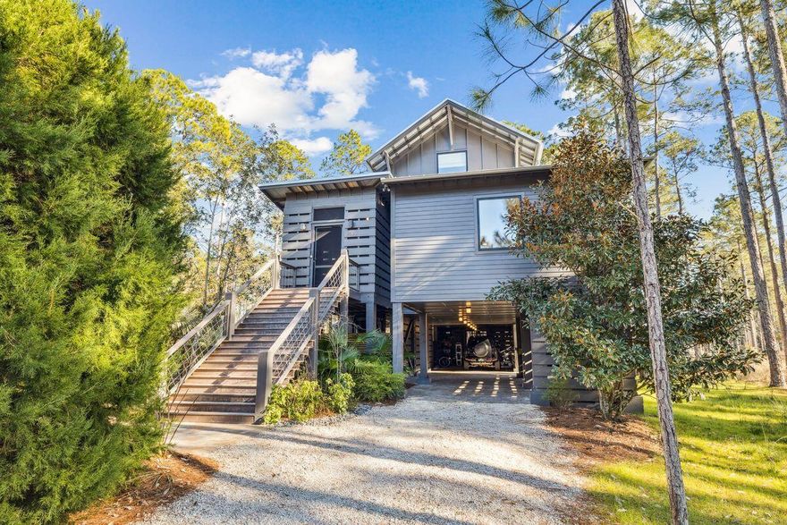 Refined RiverCamps living meets ultimate privacy and high end luxury at this beautifully transformed home on an expansive two acre homesite overlooking Mirror Lake. From the moment you arrive, the setting feels serene and welcoming, offering a rare sense of retreat 15 minutes from the emerald coast.Adapted from a Southern Living design, the residence has been thoughtfully reimagined into a warm, elegant escape with designer finishes throughout. A comprehensive renovation touched every aspect of the home, including all new mechanical systems, roof, solar panels, irrigation and pool equipment, and appliances, along with curated cabinentry, wall coverings, custom drapery, and elevated details at every turn. The result is a truly turnkey property ready for its next owner. Indoor and outdoor living blend seamlessly with nearly 1000 ft of covered porches and a fireplace extending from both the living area and the primary bedroom, creating an inviting space for year round enjoyment. The outdoor experience is further enhanced by one of the largest private pools in RiverCamps, featuring multiple sunbathing and lounging areas, covered seating, and a summer kitchen ideal for entertaining.
Parking and storage are abundant, with ample covered space for vehicles and golf carts, plus extensive storage suited for full time living. An automated lift provides convenient access from the parking level to the home's main entrance.
Set among the trees, the main level features the living area, dining room, and kitchen, along with a dedicated office offering peaceful forest views. The expansive primary suite also resides on this level and includes a private sitting area, spa inspired bath, and a large walk in closet. Upstairs, two guest suites and an additional sitting area provide comfortable and private accommodations for visitors.
The home's golf cart conveys, allowing easy access to RiverCamps' renowned amenities, including the private boat storage and launch with access to the bay, pickleball courts, a brand new community pool pavilion, and a new fitness center currently under construction.
Conveniently located just minutes from the airport, near the new hospital, and close to expanding shopping and dining options, RiverCamps offers a rare balance of natural privacy and everyday convenience. Schedule your private showing today to experience this exceptional property.
