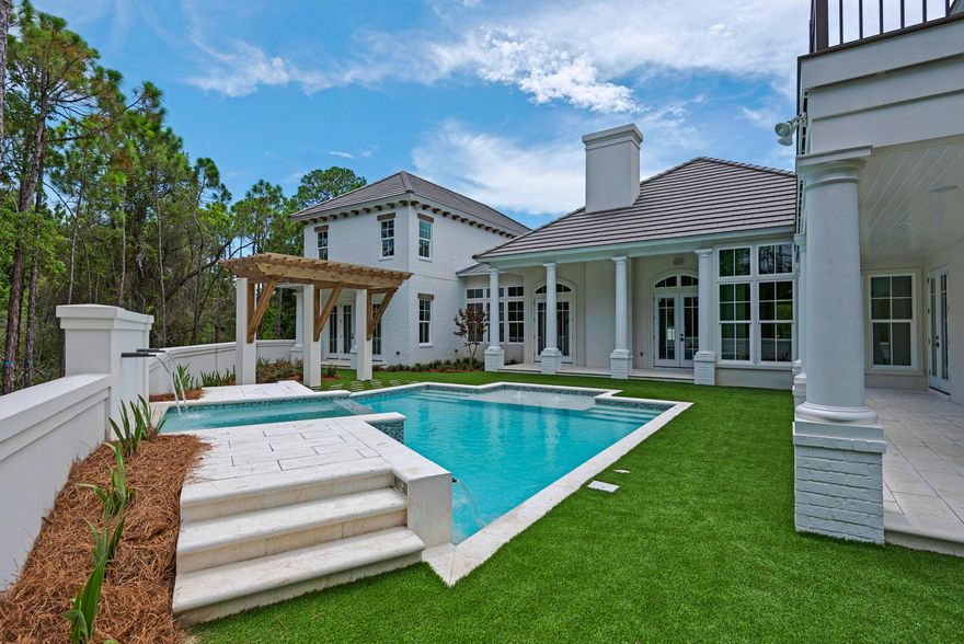 (Floor plan is listed under documents) This beautiful showcase home spares no attention to detail and will surely wow even the savviest of buyers. Upon entering through the landscaped courtyard you will be blown away by the 3 sets of solid mahogany entry doors. The foyer alone sets the standard with a gallery of archways. Every room has custom detailing including pecky cypress and coffered ceilings, custom made limestone fireplace, handmade cabinetry, and much more. This home features a split floor plan with the master bedroom downstairs just off of the large sparkling pool. An additional two bedrooms is located upstairs and full guest quarters equipped with an elevator, full kitchen, and outdoor living space are on the opposite side of the main house. The custom pool has water fountains galore and a beautiful hot tub with waterfall. The covered loggia has an outdoor fireplace, summer kitchen, and pool bath.  Words cannot describe the quality of this home.  Destin Custom Home Builders is the developer of Regatta Bay and continues to raise the standards of construction by using only the finest building materials.  Come see our work by touring this showcase home.