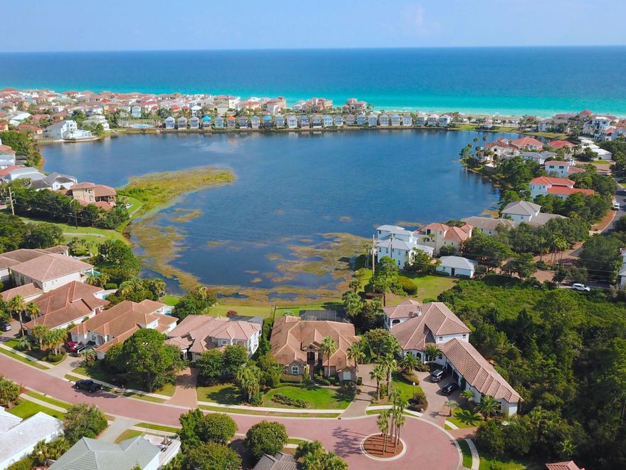 Positioned on a spacious lot in a gated community, this lakefront retreat offers desirable outdoor amenities and close proximity to beaches, shopping and recreation in Destin, Florida. Situated all on one level, this home offers four bedrooms with open living spaces and expansive lake views. Tile flooring can be found in the principal living areas, and the living room features a gas fireplace. Prepare meals in a chef's kitchen with granite countertops and stainless steel appliances. There is both a breakfast nook and formal dining area, perfect for hosting large gatherings. Double doors lead to an outdoor oasis with a screened-in pool and large deck, including a spacious fenced in backyard. Residents of Destiny East enjoy access to several amenities, including two community pools, a clubhouse, a fitness center, tennis courts, a playground, and a movie theater.