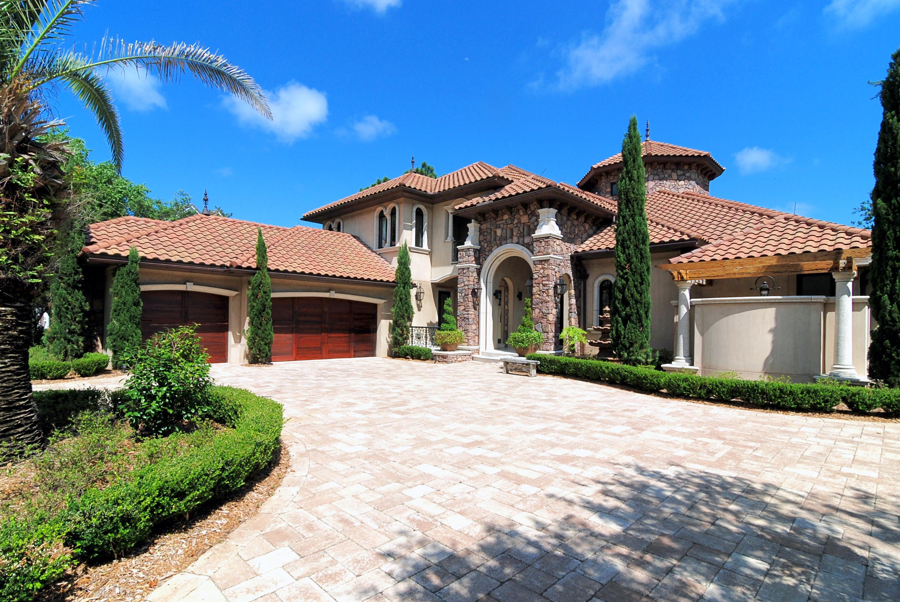 Tuscan inspired luxury home with superior craftsmanship & ICF (Insulated Concrete Form) construction.The first level custom features include: Programmable Smart house technology; 30 foot ceilings in salon with faux painted columns & walls; spectacular chandelier; water feature on one entire wall; formal dining room; sophisticated bar with temperature-controlled wine room; beautifully appointed kitchen with state-of-the-art appliances, butler's pantry, custom cabinetry & rare yellow bamboo quartz counter tops; kitchen opens to great room with built-in wall unit with fireplace & wall of glass that opens up to the courtyard & pool; luxurious master suite features a sitting area, fireplace, wet bar, chandelier, & opens to courtyard & pool area; (see photos for more features)