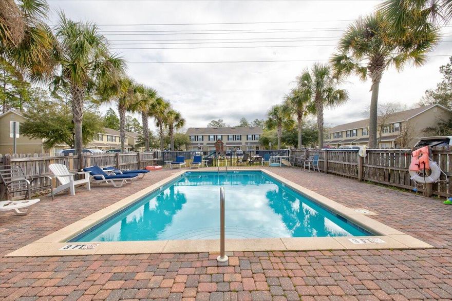 Affordable and well-maintained, 2 bedroom, 2.5 bath end unit townhome at the Palms of Freeport. This lovely community is just across from Freeport schools and only a quick drive to the beach, and it has its own children's park and an in-ground community pool, located just in front of this particular unit! This home features a spacious floor plan, upgrades including counter tops, solid wood custom cabinets, and stainless appliances (including a flat cooktop stove) in the kitchen, travertine counter tops in the bathrooms, upgraded lighting, plenty of storage, two spacious bedrooms (the master has his and hers closets), and a sliding glass door in the living room leading out to a wooden deck overlooking the wooded area behind the home. Current tenants have been in unit for years, but current market conditions indicate at least $1,550/month rental projections.