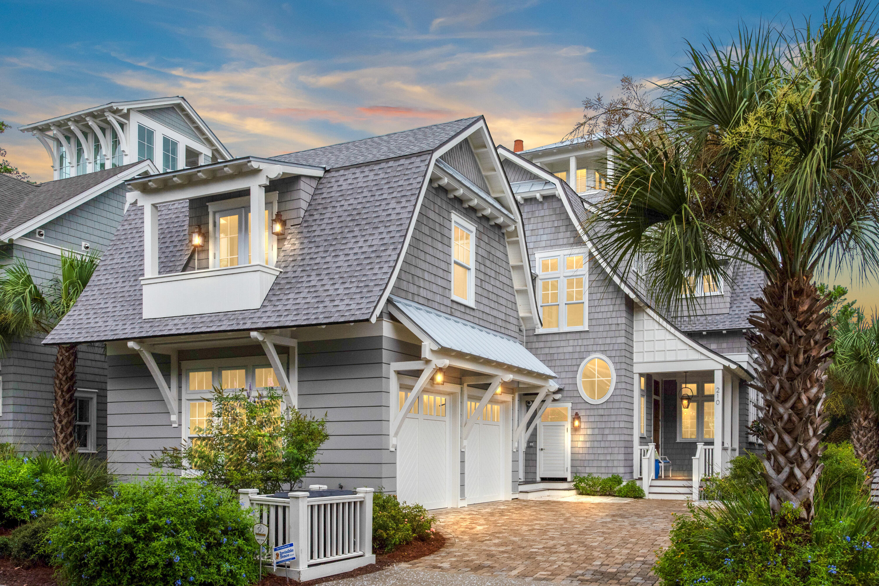 This luxury beach house breaks with conformity to offer a refreshingly modern home with outstanding design features. Hand-scraped hardwood flooring and 12-ft. ceilings grace the living area along with an open fireplace. Look up to admire the reclaimed beams in the family room and cathedral ceiling in the master bedroom. Pristine white decor and full-height windows create a light contemporary dining space with pool and tree views.