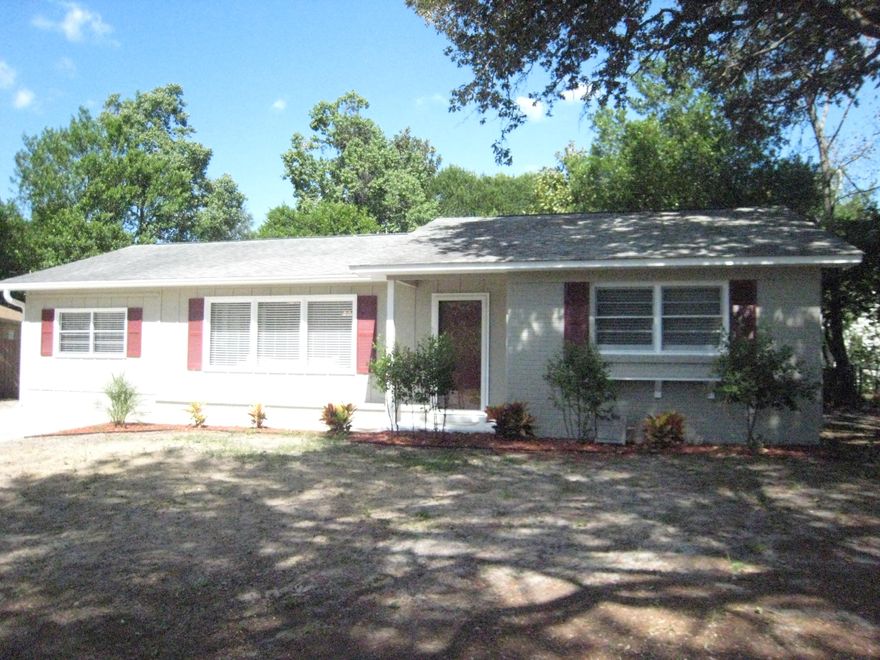 Renovated and sparkling clean - ready for you to move in! Open floor plan with lots of space and natural light. This home has 3 bedrooms and 1 1/2 baths with a large living, dining and kitchen. There is a bonus too - a glass/screened sunroom for year-round enjoyment! The house has been repainted with neutral colors with new fans and light fixtures and window blinds. The floors are all new (tile, carpet and wood laminate). There are also new kitchen cabinets (self-closing), countertops, sink, faucets, bathroom vanities and toilets! There is a new wooden deck off the sunroom too! If you don't need the third bedroom, this large bedroom can be used as a family room. The back yard is all fenced too. What a grand opportunity for you - schedule a showing today!