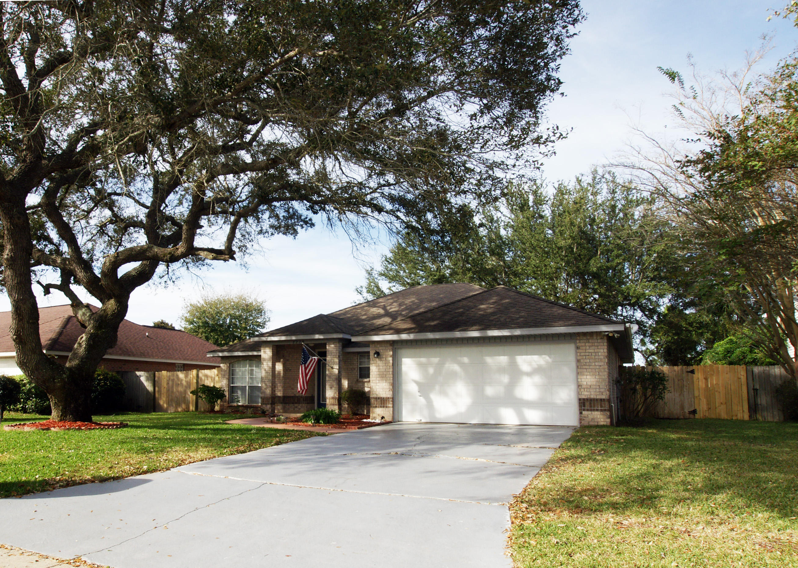 Low maintenance all brick home with large shady oak trees. Landscaped front and back yards. Access to the East Bay is a short walk away. Not in a special flood zone (does not require flood insurance). Room for boat parking in side yard. Large kitchen. Open floor plan. Master bath has double vanities. Both baths were updated in 2014 with new counter tops and sinks. Heat pump system and programmable thermostat in 2014; 10 yr warranty!New dishwasher. Fireplace. Split bedroom. Formal dining room with new pocket door offers flexibility as office or 4th bedroom. Blinds, washer/dryer, refrigerator, & range included. Walk-in closets in master/ his and hers. Large closets in other two bedrooms. Pantry in kitchen and large inside laundry room. Fig and orange tree.