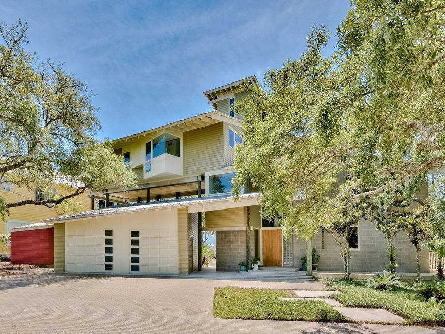 An architectural masterpiece created by renowned architect Steven Shortridge, is located on a rare coastal dune lake cradling the Gulf of Mexico. The property's natural surroundings are highlighted with expansive windows and extraordinary outdoor living spaces. A dramatic entry, towering pole columns and angled Cypress beams command attention from the moment you step inside. An open floor plan offers comfortable entertaining spaces, and the living room features ''Noon Day Prayer,'' a large original painting by well-known artist Darren Waterston. Take in beautiful views from several porches and decks including a fourth-floor tower that offers cinematic views of Eastern Lake and the gulf.