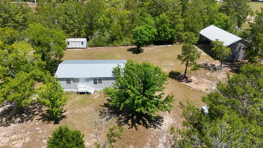 Completely and TOTALLY renovated 3bed/2 bath home, nestled on a sprawling 8.9-acre lot, located beautifully just off I-10 north of Niceville and midway between Crestview and DeFuniak Springs. The home features all new drywall, a modern kitchen with all wood cabinets, sleek quartz countertops and LVP throughout. Large master suite with spa-like walk-in shower and his/hers walk-in closets. There is a new metal roof, all new plumbing lines and closed cell floor insulation; Mossyhead water plus well as back up or future irrigation. Step outside to enjoy the existing fenced garden area, ideal for growing your own food or keeping animals, with the wooded area prime for exploring. The 4-bay pole barn, additional storage shed and chicken coop with run, complete the country life possibilities.