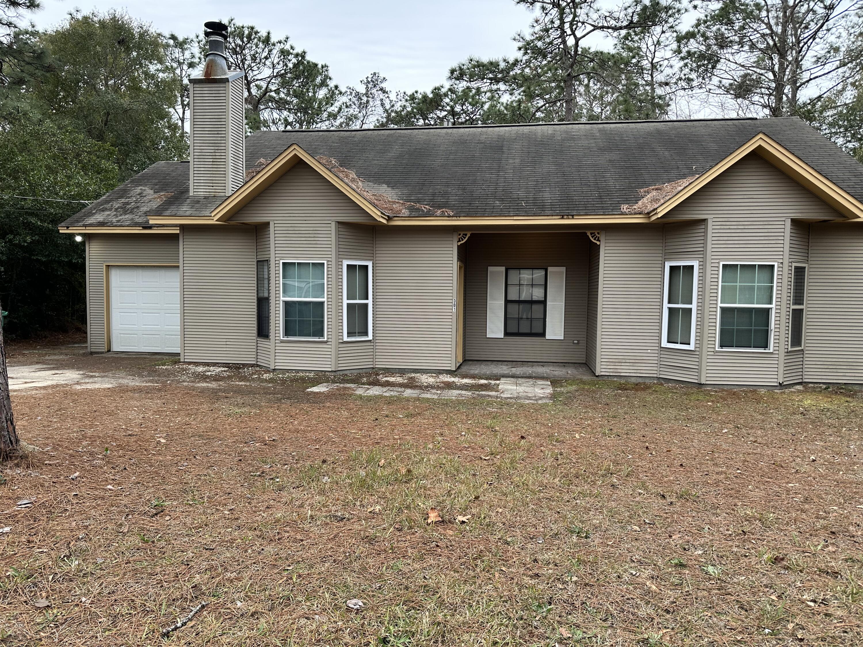 This 3 Bedroom 2 Bath home is located in Central Crestview close to Shopping, Schools and Restaurants!  Large Backyard that is fenced and features a Covered Porch.  This home has High Ceilings in the Living Area with a Fireplace for cozy evenings.  New tile throughout the home!  Call for more information.