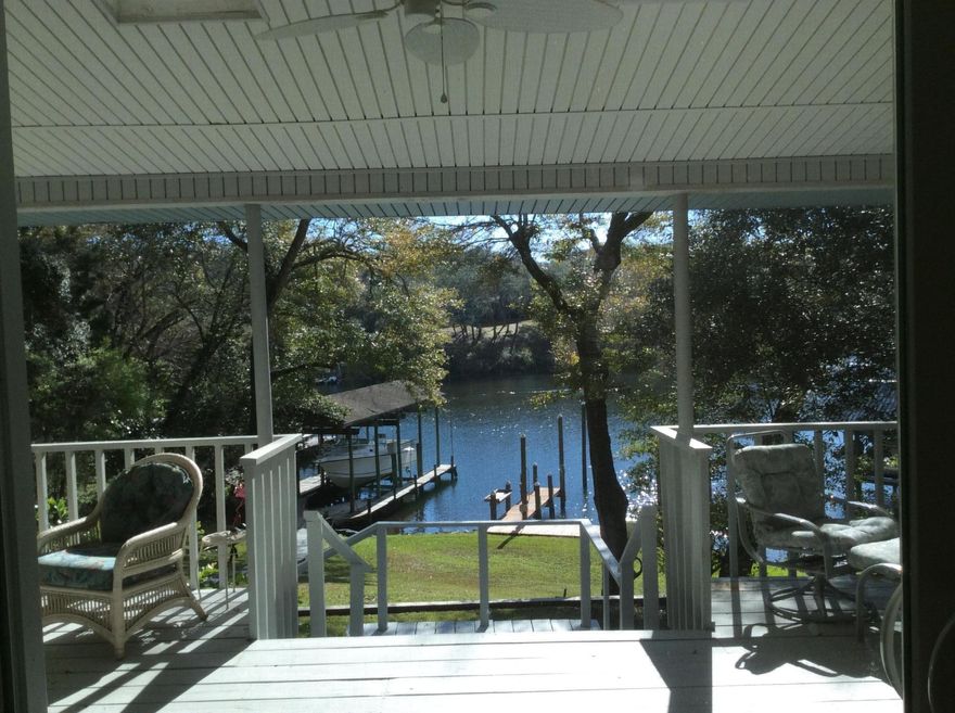 Waterfront HIGH and DRY...Gorgeous home with walk out basement, panoramic views of Chula Vista Bayou. Master on the main floor with newly remodeled walk in shower with skylight and multiple shower towers surrounded by waterfall tile design. Large walk in closet with washer and dryer hook up and central vacuum system. Wine cellar under walk in closet on main floor. Open floor plan with lots of space for entertaining. Open kitchen with granite and sub zero refrigerator. Gathering area with granite topped bar and wet bar for entertaining. Foyer and kitchen real hard wood flooring. Spiral staircase leads you to a finished walk out basement. This level also has a laundry room, two master suites with their own full bathrooms and an additional fourth bedroom. Step outside onto an immense covered deck.  Copper wiring through out home. Second washer/dryer hookup with large laundry downstairs.  Huge over-sized two car garage with workshop. Four car attached covered car port. Covered boat lift holds a 36 foot/15,000 lb boat. Hurricane Impact storm windows. Home Warranty. Home is move in ready.  Hurry this Bayou Beauty will not last long!!!  Make your appointment to view today. All information deemed reliable. Buyer to verify.