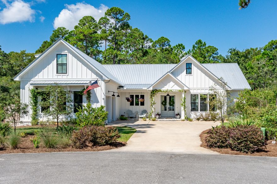 Rare opportunity to own a stunning home in the highly desirable gated neighborhood of Seclusion Bay! This unique property sits on over half an acre in the middle of a cul-de-sac with woods lining the back of the lot for ultimate privacy. Plenty of room to design and add your own pool!The heart of the home boasts a spacious open layout with a custom Venetian plastered kitchen hood and fireplace creating a cohesive look. Cafe appliances, counter to ceiling herringbone tile with a working walk-in pantry creates a stunning kitchen.Featuring a home office with a built in oak desk and shelving. Each downstairs bathroom showcases exquisite designer tile work. Finish your day fishing and watching the sunset on the private neighborhood dock. All measurements are approximate.