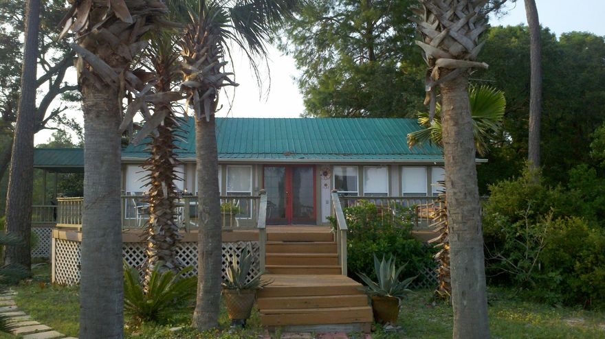 RELAX and WATCH the BAY Go By! Big deck perfect for family & friends to gather. Great view of the Bay and of course, endless water fun & fishing.This is a unique second home with easy livin' in mind. Open living room and kitchen with full view of the Bay. Large Master suite. Jack & Jill bath between two guest bedrooms. Detached garage and storage area. Concrete seawall and sandy beach area - rare find for this area!! Close to Intracoastal Waterway - watch the barges and fishing boats travel the waterways! Call to see today!