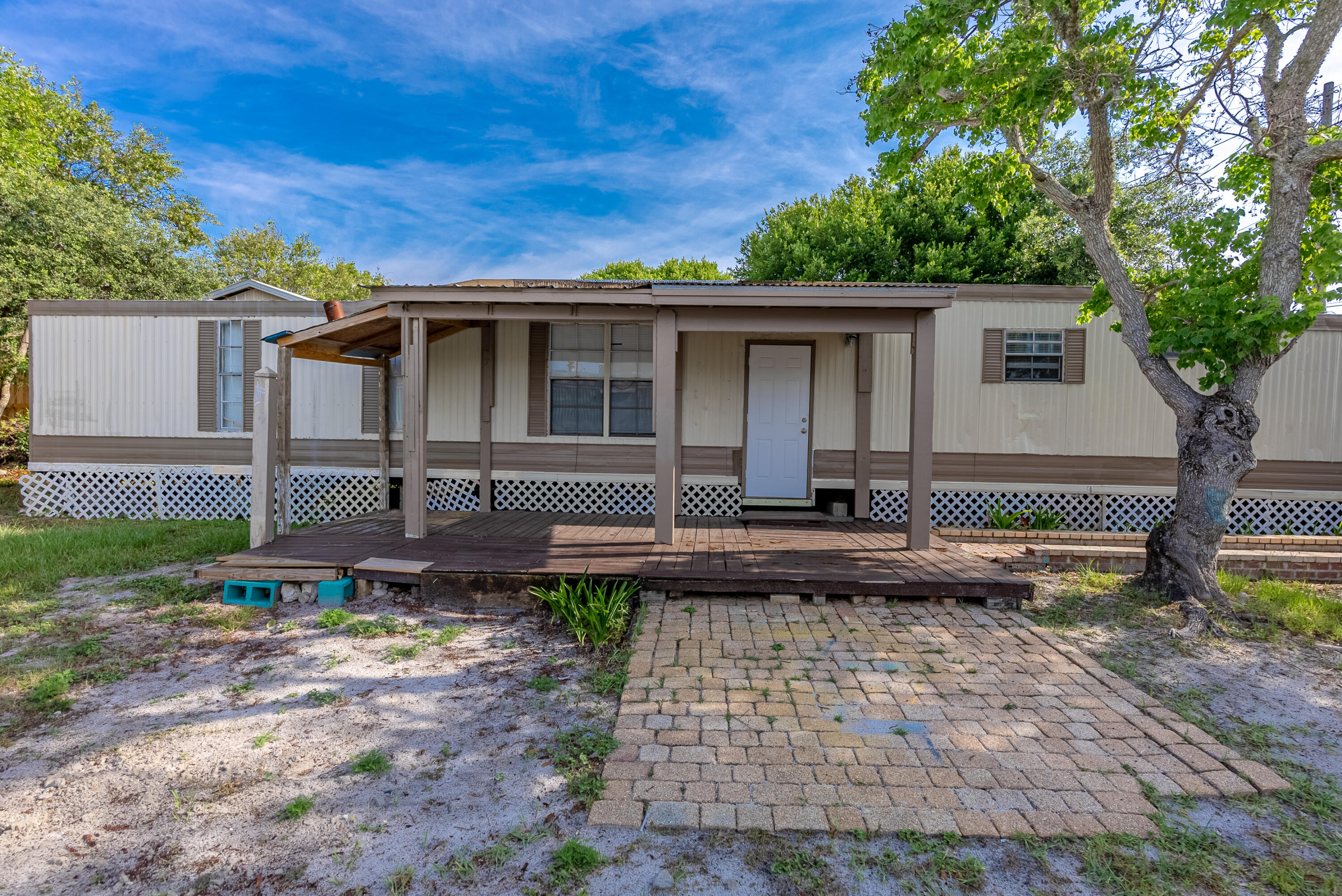 Calling Investors & Bargain Hunters! This mobile home is in need of your expertise & TLC. This mobile home sits on a beautiful lot, which backs up to Santa Monica Beachl on the West End of Panama city Beach. Priced to allow for repairs. CASH OFFER ONLY!This home has some great features such as a an open living kitchen area, a split bedroom floor plan,a large covered front deck ,nice and shaded, a and No Association fees. Yay! This home would make the perfect get a way or investment piece.Only a few minutes to Pier Park,the 30A corridor and of course our Beautiful Beach.Come seeAwesome opportunity in Laguna beach .This fixer -upper mobile would be a great project !Redo for a short. term rental,2nd home or full time residence building lot.