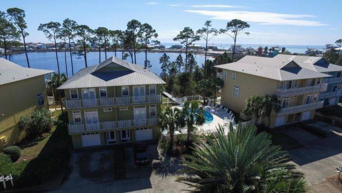 ATTENTION INVESTORS! ENJOY GULF AND LAKE VIEWS FROM THIS 4 BEDROOM,30A TOWNHOME WITH GREAT RENTAL POTENTIAL! Dune Breeze Villas is comprised of just 9 duplexes and 18 townhomes and is situated along the Northern shore of Oyster Lake, a rare Coastal Dune lake, at the quiet, West end of 30A. It features a community pool and dock overlooking the lake and a paved path for a short golf cart or bike ride to the Beach. This fully furnished, 4 bedroom, 4 bath townhome is located at the end of a cul-de-sac and is a rare find. Stunning views of the lake and Gulf are enjoyed from the 2nd and 3rd floor long, covered balconies. The first floor offers a one car garage and den with full bath (can be easily converted to a bedroom.)The second level has a 'Coastal' feel with a generous