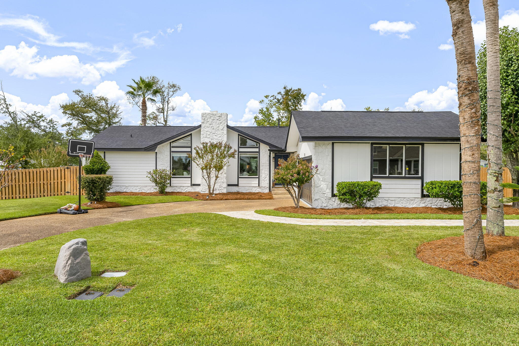 Waelcome to this absolutely stunning completely remodeled smart home, an open concept floor plan bathed in natural light, featuring elegant new LVP flooring, new windows. Forget the hassle and cost of renovations, this is a true ''turn-key'', every detail has been meticulously updated and designed for modern living. Located just a steps from community parks, boat ramp, shopping, top-rated schools, and local amenities. 3BR, 2BH. Master bedroom with walk in closet, slide doors that leads to a small patio and backyard, ideal for mornings coffee. Split-bedroom, large sunroom, living room boast a beamed cathedral ceiling, stoned fireplace. Levoler Blinds in 2025, in the entire house. Two cars garage & paved parking for large vehicle.