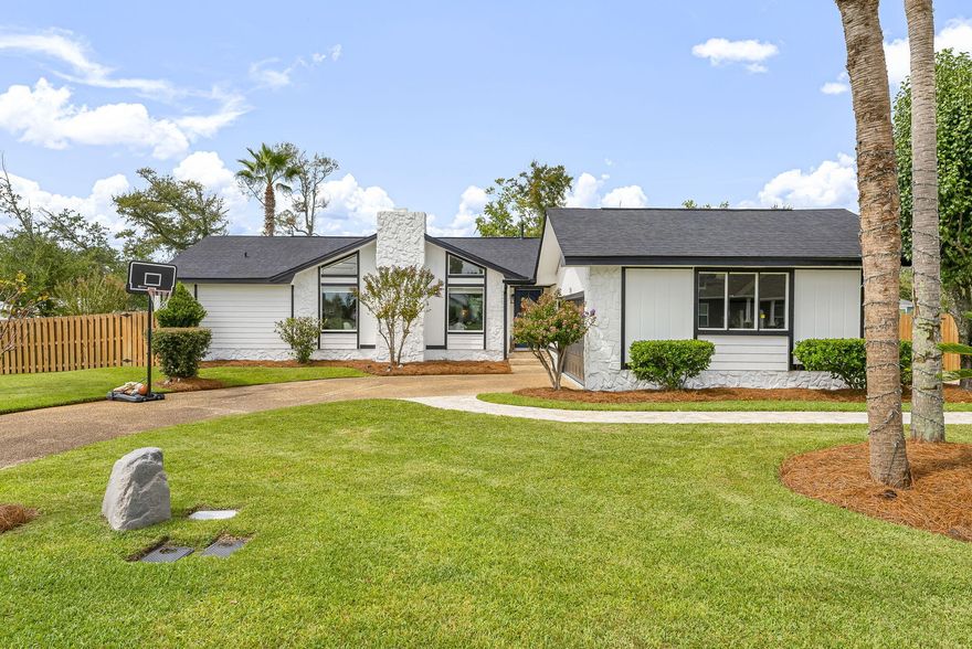 Waelcome to this absolutely stunning completely remodeled smart home, an open concept floor plan bathed in natural light, featuring elegant new LVP flooring, new windows.  Forget the hassle and cost of renovations, this is a true ''turn-key'', every detail has been meticulously updated and designed for modern living. Located just a steps from  community parks, boat ramp, shopping, top-rated schools, and local amenities. 3BR, 2BH. Master bedroom with walk in closet, slide doors that leads to a small patio and  backyard, ideal for mornings coffee. Split-bedroom, large sunroom,  living room boast a beamed cathedral ceiling, stoned fireplace. Levoler Blinds in 2025, in the entire house. Two cars garage & paved parking for large vehicle.